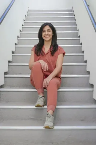 Professional physician portrait of doctor in coral medical scrubs for medical practice headshot Phoenix Arizona